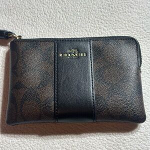 Coach Corner Zip Leather Wristlet in black and brown.